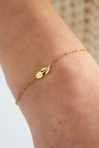 Delicate gold bracelet with leaf design, minimalist and elegant wrist accessory